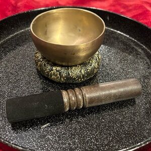 Preowned small brass singing bowl with stand cushion